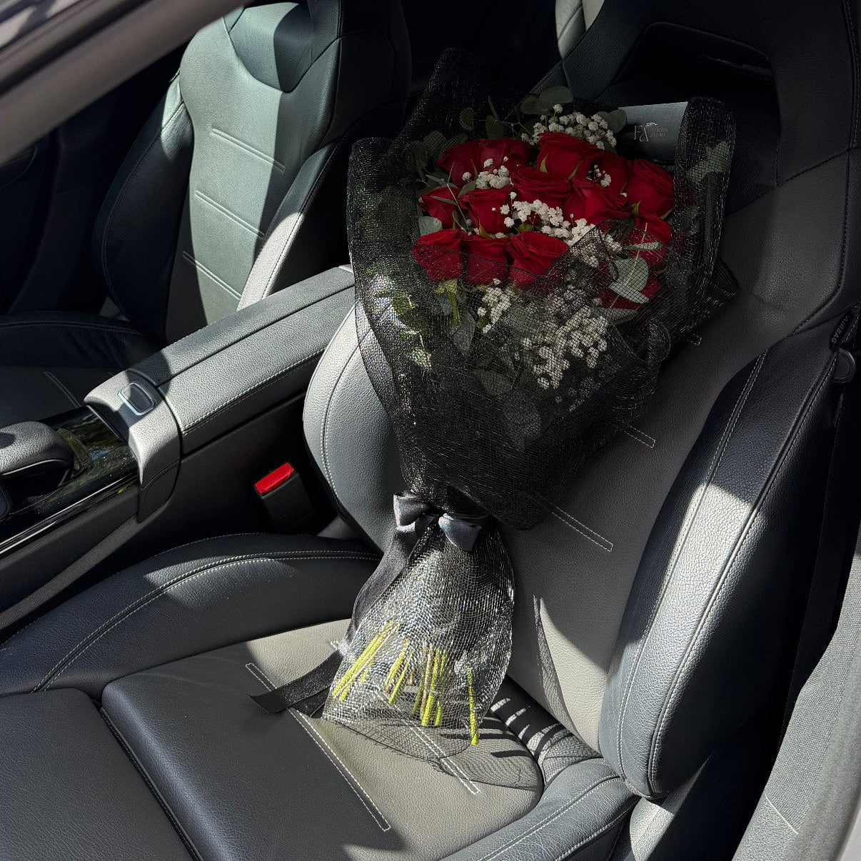 Dozen red roses with gypsophila